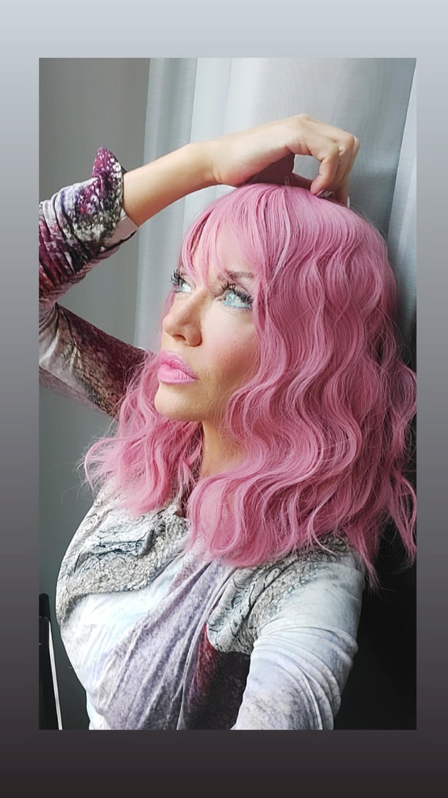 Pink wave wig styled with a marbled velvet top