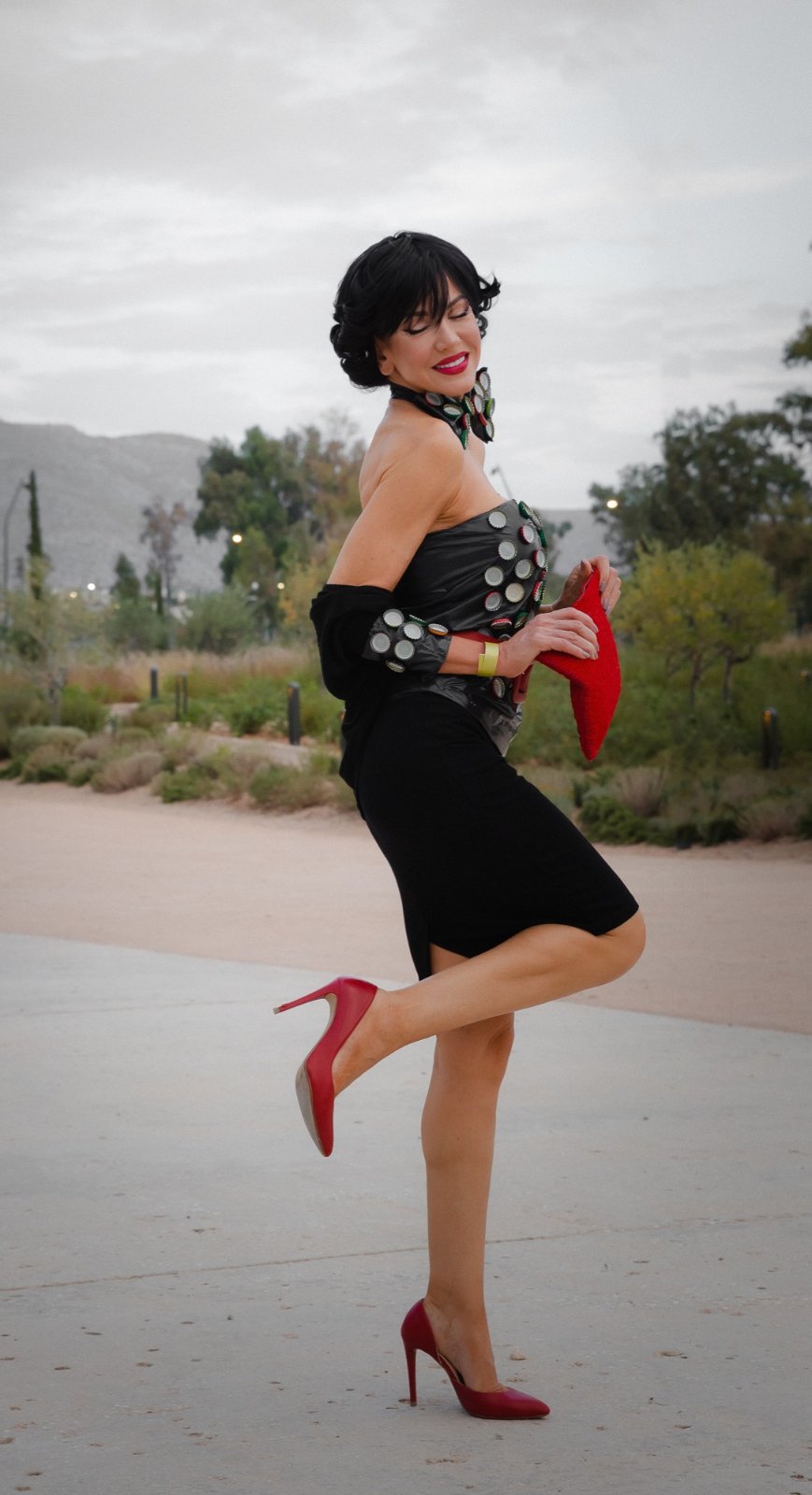 Bottle-cap corset with black pencil skirt and red heels