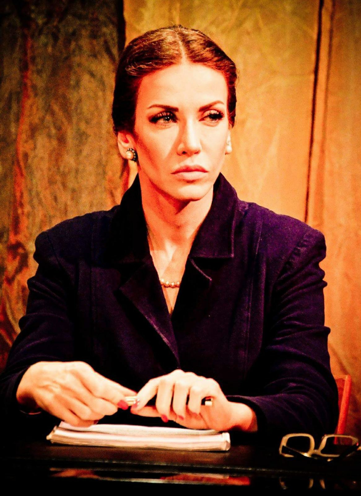 Theatre role in a tailored navy blazer