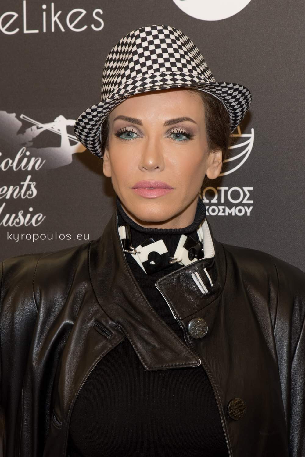 Checkerboard hat with a black leather trench