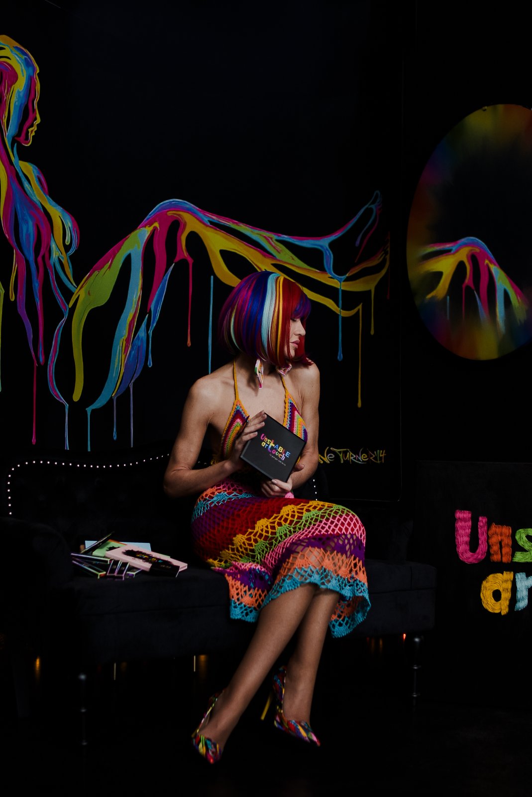 Holding the Unstable Art Touch palette on the black sofa