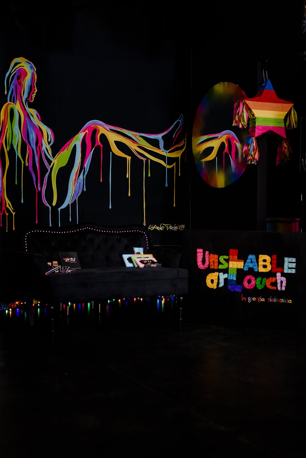 Unstable Art Touch studio lounge with velvet sofa and fairy lights