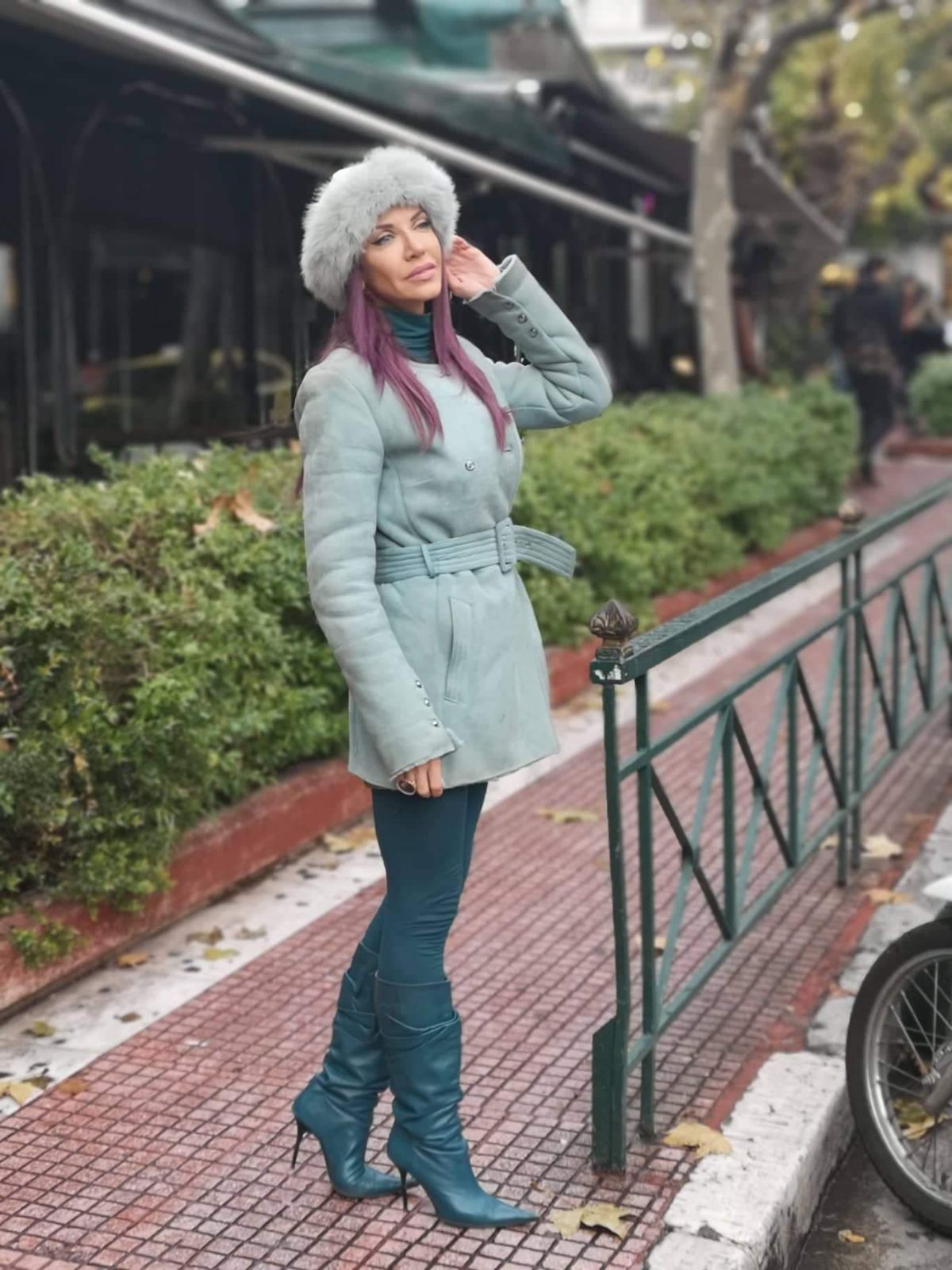 Pale blue shearling coat with fur hat and teal boots
