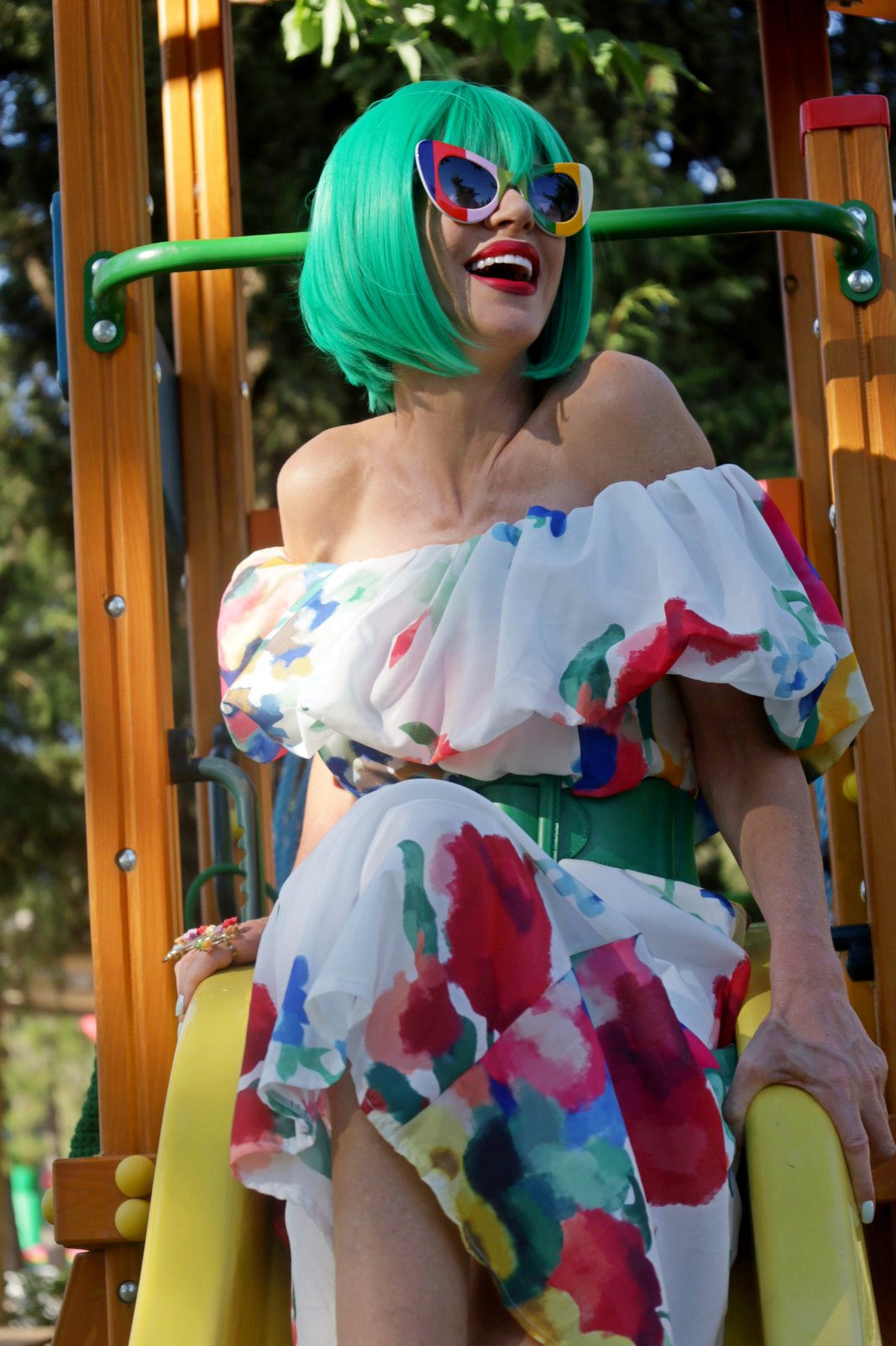 Green bob and multicolour sunglasses on playground bars