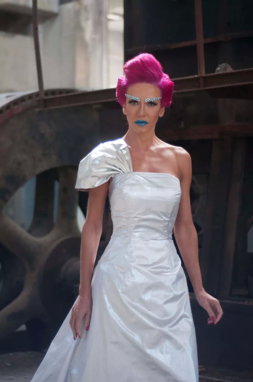 Magenta updo and jewelled brows with a silk one-shoulder gown